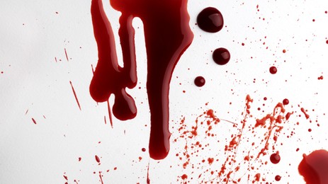 Stain and splashes of blood on light grey background