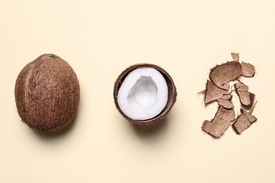 Flat lay composition with coconuts on beige background