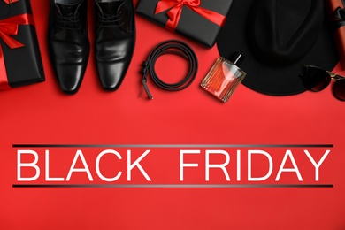Flat lay composition with gift boxes, male accessories and phrase Black Friday on red background