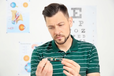 Young man with glasses visiting ophthalmologist