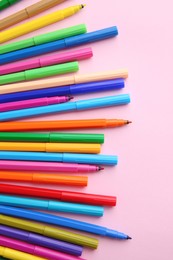 Set of felt tip pens on pink background, flat lay. Diversity concept