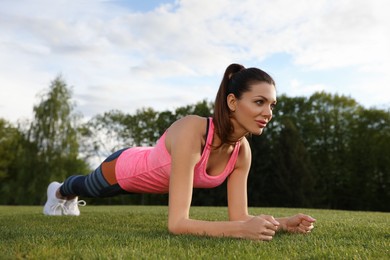 Beautiful woman doing fitness exercise in morning outdoors