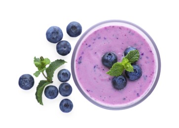 Photo of Glass of blueberry smoothie with fresh berries and mint on white background, top view