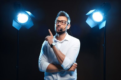 Photo of Motivational speaker with headset performing on stage