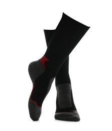 Woman wearing thermal socks on white background, closeup of legs. Winter sport clothes