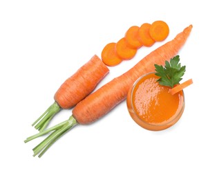 Photo of Freshly made carrot juice in glass on white background, top view