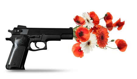 Beautiful blooming flowers and handgun on white background. Peace instead of war