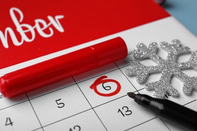 Saint Nicholas Day. Calendar with marked date December 6, marker and snowflake, closeup