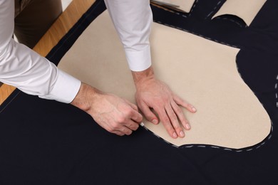 Dressmaker marking fabric with chalk, closeup view