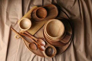 Photo of Set of wooden dishware and utensils on table, flat lay