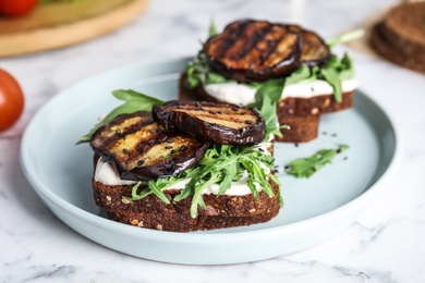 Delicious eggplant sandwiches served on white marble table