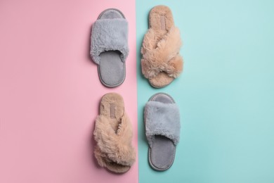 Different soft fluffy slippers on color background, flat lay