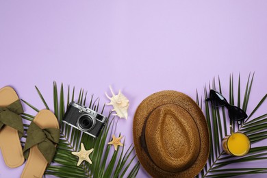 Flat lay composition with beach objects on violet background, space for text