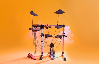 Modern electronic drum kit and smoke on yellow background. Musical instrument