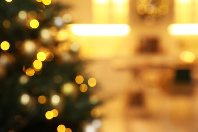 Blurred view of beautifully decorated Christmas tree indoors