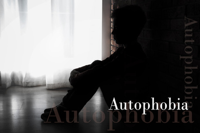Depressed little boy sitting alone near brick wall. Autophobia - fear of isolation