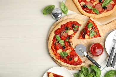 Delicious homemade pita pizza on white wooden table, flat lay. Space for text