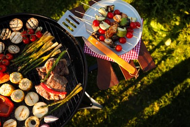 Cooked food products and grill barbecue outdoors, top view