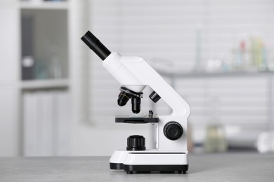 Modern medical microscope on grey table in laboratory