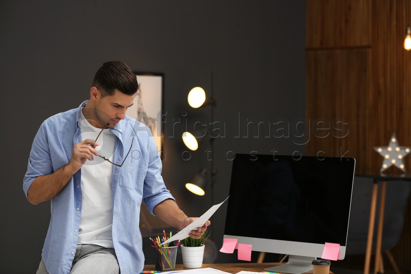 Photo of Male designer working in office. Creative profession