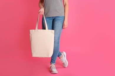 Woman with eco bag on color background. Mock up for design