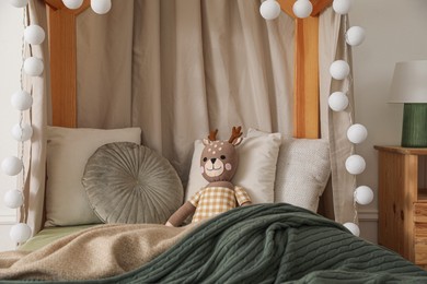Toy deer on bed in child's room