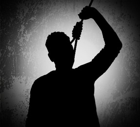 Silhouette of depressed man with rope noose on neck. Suicide concept 