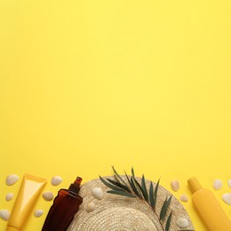 Photo of Sun protection products and beach accessories on yellow background, flat lay. Space for text