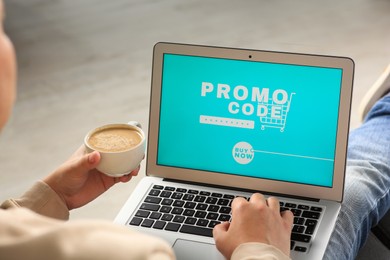Man with laptop activating promo code while doing online shopping indoors, closeup
