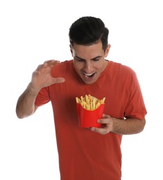 Photo of Hungry man with French fries on white background