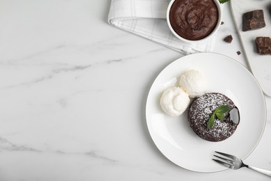 Delicious fresh fondant with hot chocolate, mint and ice cream served on white table, flat lay. Space for text