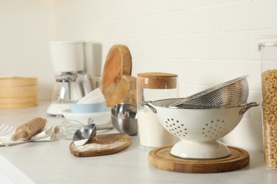 Cooking utensils and products on kitchen counter