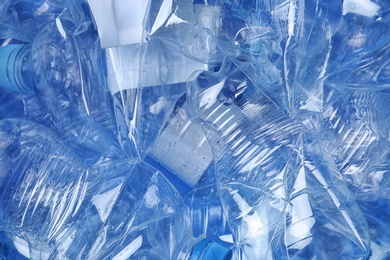 Pile of crumpled plastic bottles as background, closeup. Recycling problem