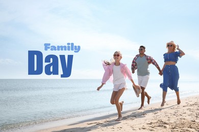 Image of Happy parents and their daughter on sandy beach near sea. Happy Family Day