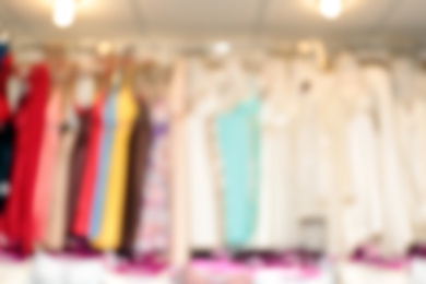 Blurred view of female nighties on hangers in underwear shop