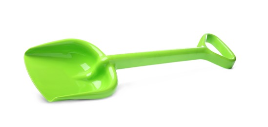 Green plastic toy shovel isolated on white