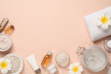 Photo of Flat lay composition with body scrubs on pink background, space for text