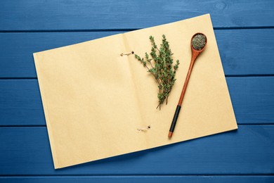 Photo of Blank recipe book and thyme on blue wooden table, top view. Space for text