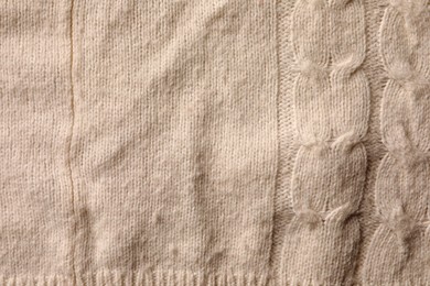 Photo of Knitted cloth with lint as background, top view. Before using of fabric shaver