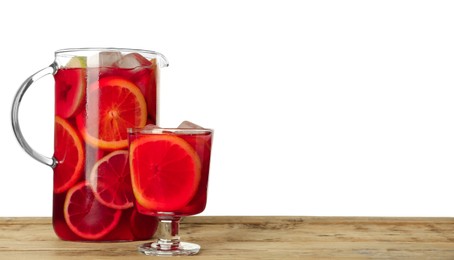 Glass and jug of Red Sangria on wooden table against white background. Space for text