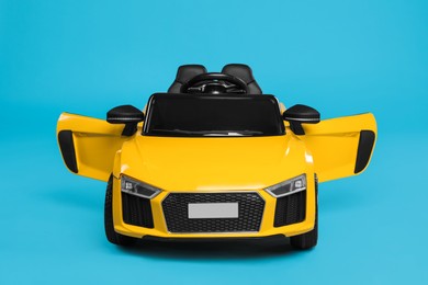 Child's electric toy car on light blue background