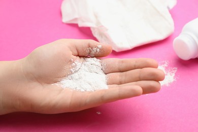 Photo of Woman with dusting powder on pink background, closeup