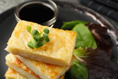 Delicious turnip cake with herbs on table, closeup