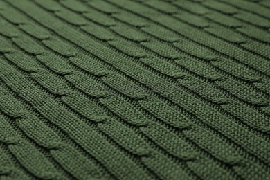 Dark green knitted wool texture as background, closeup