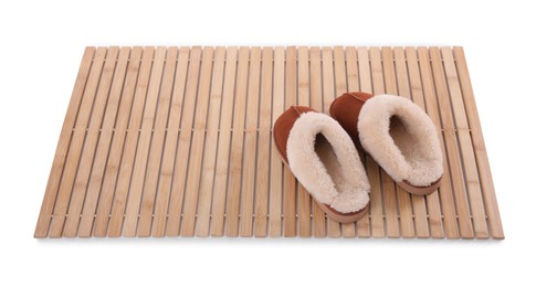 Bamboo rug with soft slippers isolated on white. Bath accessory
