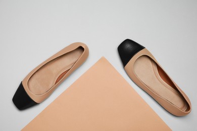 Photo of Pair of new stylish square toe ballet flats on colorful background, flat lay
