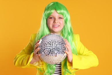 Cute indie girl with disco ball on yellow background