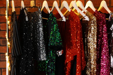 Photo of Collection of different beautiful women's party dresses in showroom. Stylish trendy clothes for high school prom