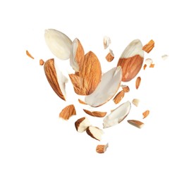 Pieces of tasty almonds falling on white background