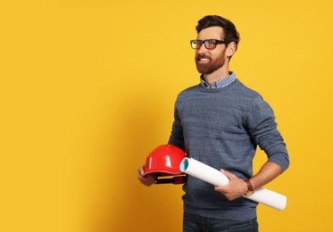 Professional engineer with hard hat and draft on yellow background, space for text